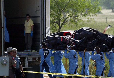 Police carry another victim from the shocking scene.